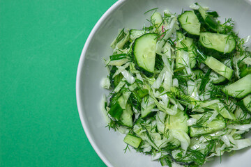 Obraz premium Diet salad of cucumbers and cabbage. Healthy diet. Vegetarian food