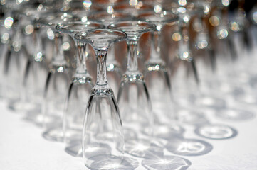 A lot of empty wineglasses on a table.
