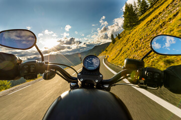 Motorcycle driver riding on mountains highway, handlebars view, Dolomites, central Europe. - obrazy, fototapety, plakaty