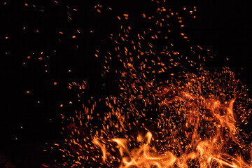 Fototapeta na wymiar Fire flames on black background, close-up