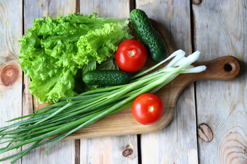 Set of greens on a wooden board. Green onions, salad, vegetables. Healthy diet. Salad products.
