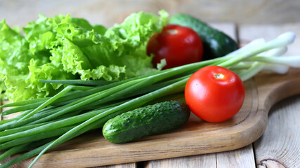 Set of greens on a wooden board. Green onions, salad, vegetables. Healthy diet. Salad products.