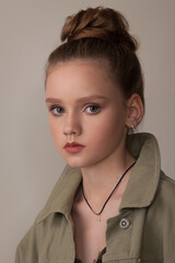 portrait of a teenage girl in a khaki jacket