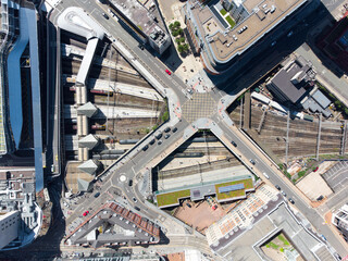 Birmingham New Street Grand Central Station England UK Aerial view of city centre with crossroads train station. Big transport hub with trains at platforms on sunny day drone perspective.
