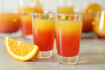Tequila sunrise cocktails on white textured table, close up