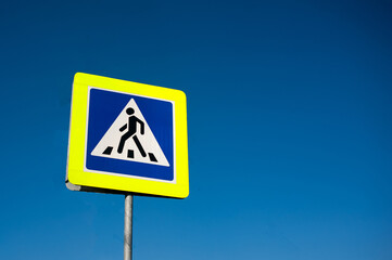 traffic sign - pedestrian crossing road against the sky