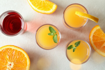 Tequila sunrise cocktails on white textured background, top view