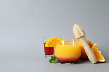 Concept of preparing Tequila sunrise cocktail on gray background