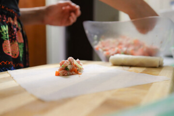 person preparing springrolls 