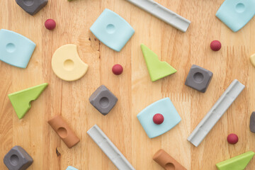 Set of colorful geometric cube or block toy on wooden background. Abstract pattern design composition by shape and form. Education, business solution and creative design product development concept.