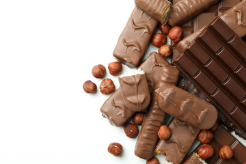 Different tasty candy bars on white background