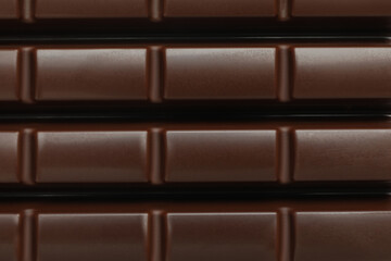 Tasty chocolate bar on whole background, close up