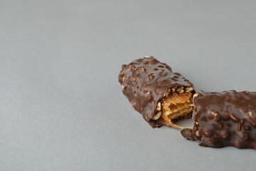 Tasty chocolate candy bar on gray background