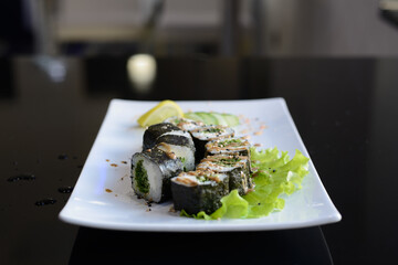 Sushi rolls on white dish. Japanese food.