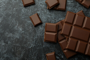Tasty chocolate bars on black smokey background