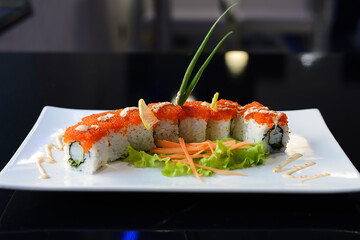 Sushi rolls on white dish. Japanese food.