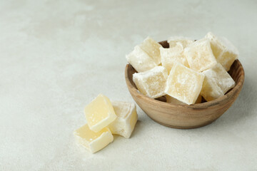 Bowl with turkish delight cubes on white textured background
