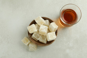 Tea and delicious turkish delight on white textured background