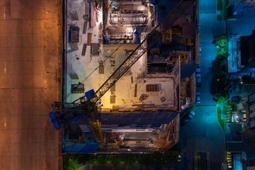 Top view of construction working high building at night time