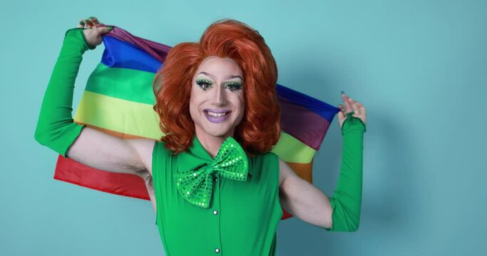 Happy drag queen holding rainbow flag - Lgbtq and gay pride concept