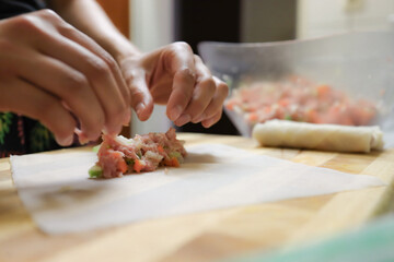 person preparing springrolls 