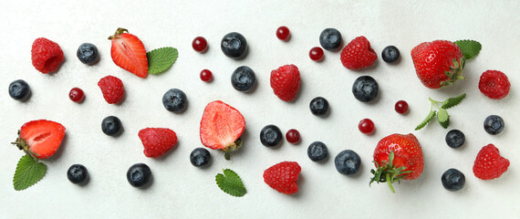 Fototapeta na wymiar Delicious fresh berry mix on white textured background