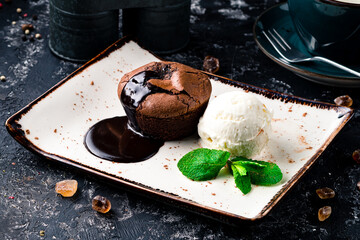 Warm dessert chocolate cake Fondant served on plate with ice-cream ball