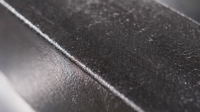 Close up at the surface of processed and polished silver bar at the factory