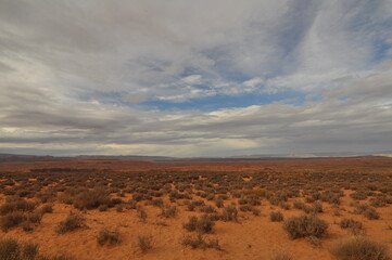 Pan view of american desert under beautiful cloudy sky in Glen Canyon near town Page,  Arizona, USA