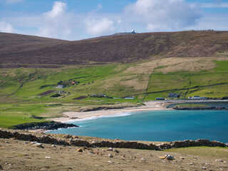 With sunshine on turquoise water, the pristine, deserted Norwick beach on the island of Unst, Shetland, UK