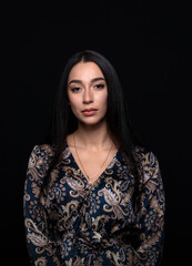 portrait of a young woman in the studio on a dark background