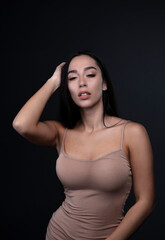 Fototapeta premium portrait of a young woman in the studio on a dark background