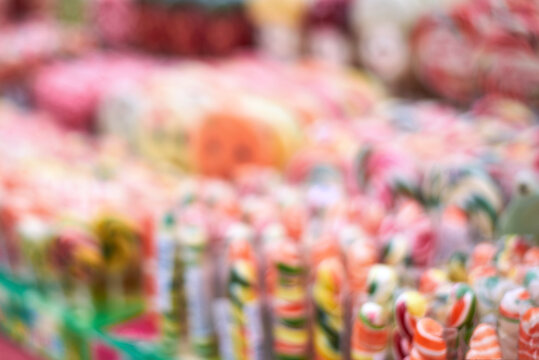 Image out of focus, tasty colorful lollipops different shapes on the counter fair.