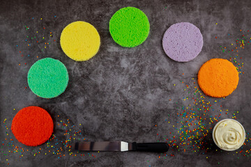 Making rainbow layer cake with white cream.