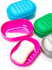 Travel soap in plastic soap dish isolated on white background