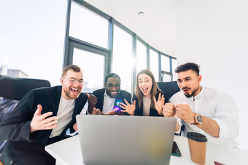 Obraz premium Group of multiracial finance company employees celebrate the company's success