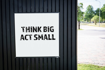 Think Big Act Small. Advertising poster on the street