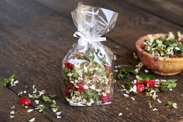 Homemade tea mix made from cherry blossoms and young leaves and dried cherries in a cellophane bag