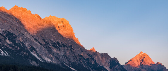 Alpenglow in the Dolomites during sunset - banner