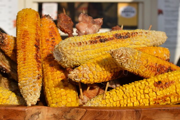 Grilled corn on wooden skewers