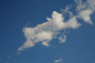 Fototapeta na wymiar White clouds in the blue sky. Horizontal frame.