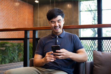 man using cell phone hand holding mobile texting message contact us.chatting,search internet...