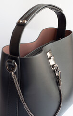 small black leather female hand bag isolated over white close-up . view from above. casual