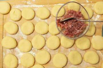 dough circles stuffed with roses on a silicone dough mat