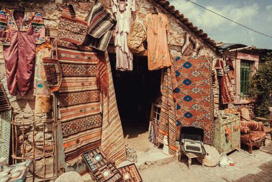 Street market with antique asian carpets in vintage shops, Turkey.