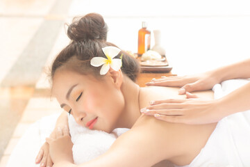 Obraz na płótnie Canvas Beautiful asian woman lying massage treatment with happy mood on vacation day.Wellness body care and spa aromatheraphy concept.
