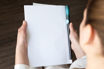 Female hands open blank catalog, magazines, book mock up