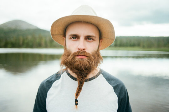 Man with braided beard near lake