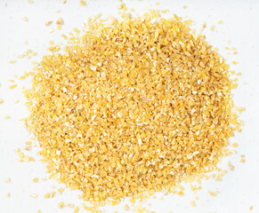 crushed polished wheat grains close up on gray