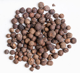 pile of allspice jamaica pepper close up on gray